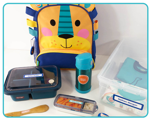 Essential daycare items including bottles, sippy cups, lunch containers, and supplies all properly labeled with waterproof name labels for first-time parents starting daycare